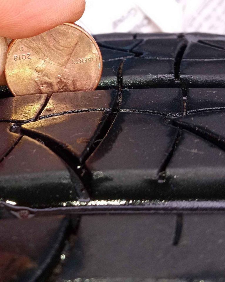 coin shown next to tire